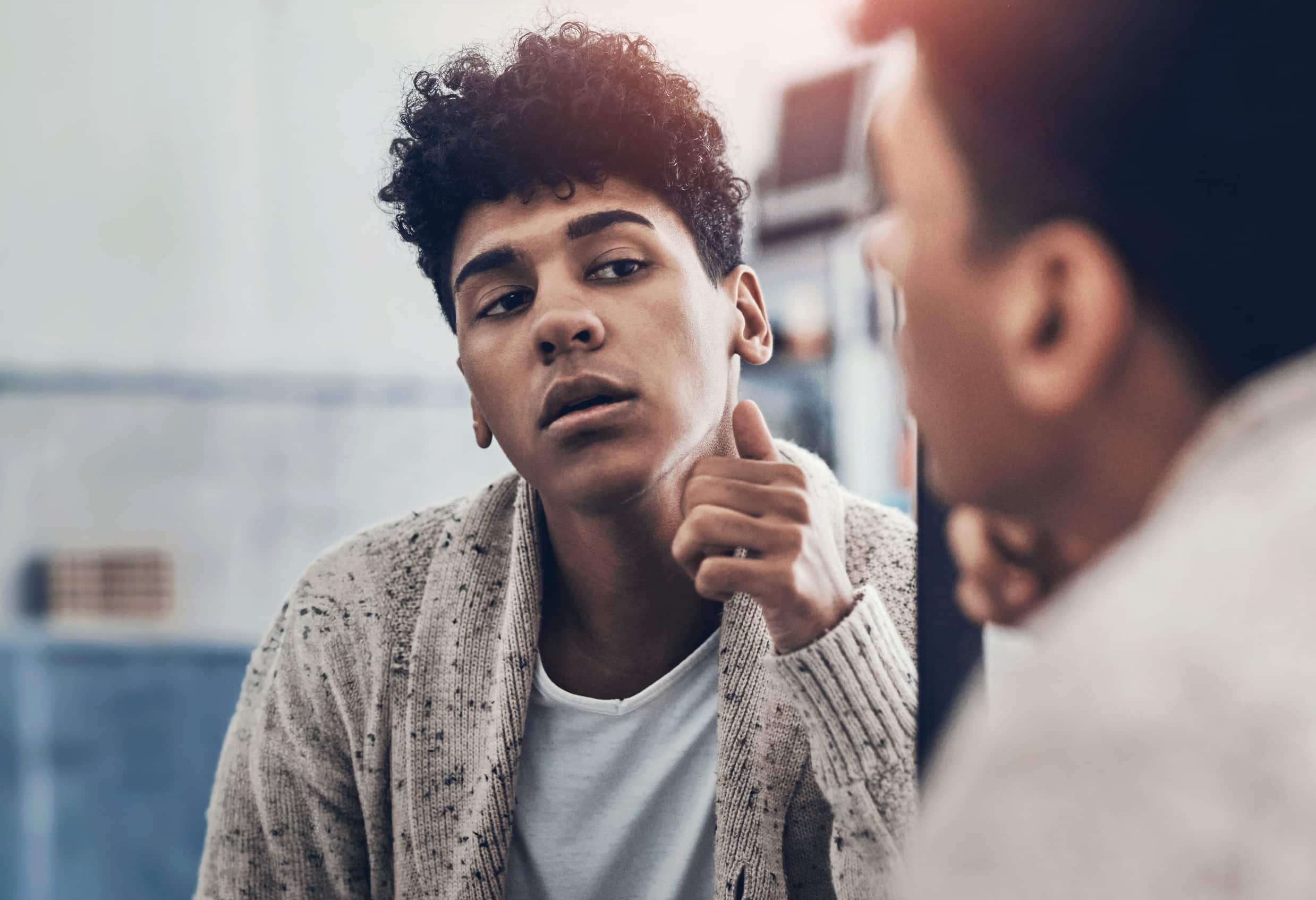 young man looking into a mirror
