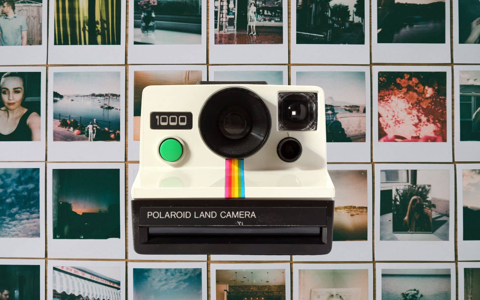 Polaroid camera on background of polaroid photos