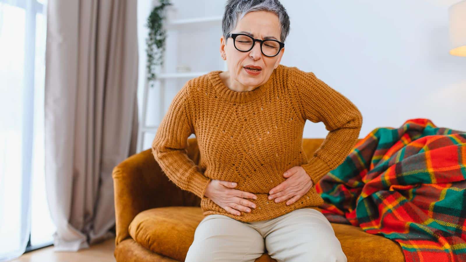 senior with IBS gut stomach pain. hryshchyshen via 123rf
