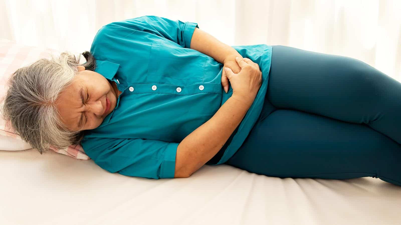 senior woman gut stomach pain. chalermphon via 123rf