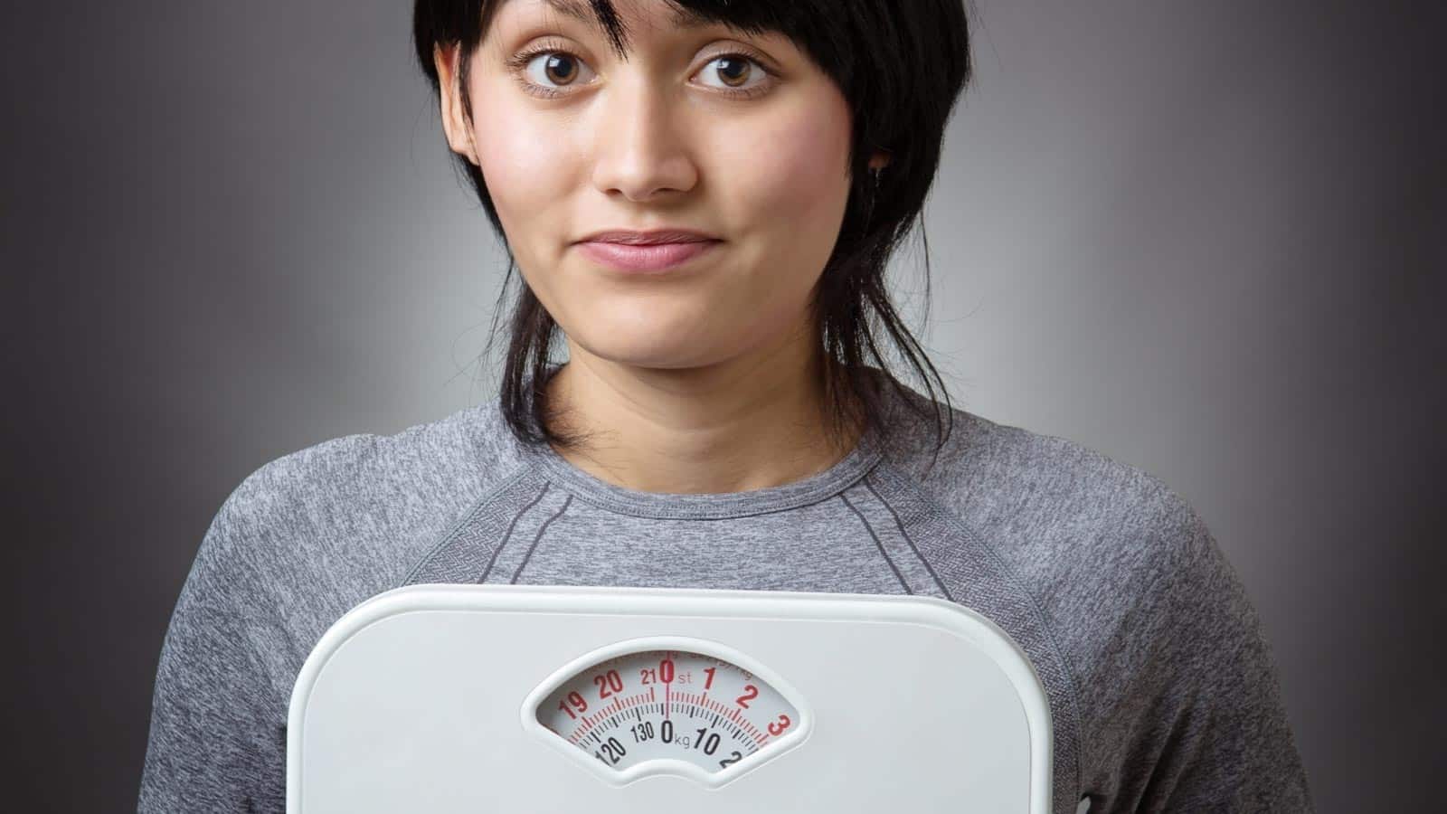 woman holding scale. jayfish via 123rf