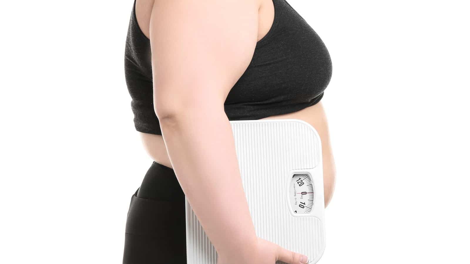 woman holding scale. liudmilachernetska via 123