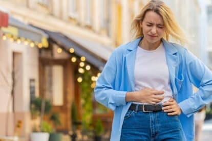 woman holding stomach. gut pain. efurorstudio via 123rf