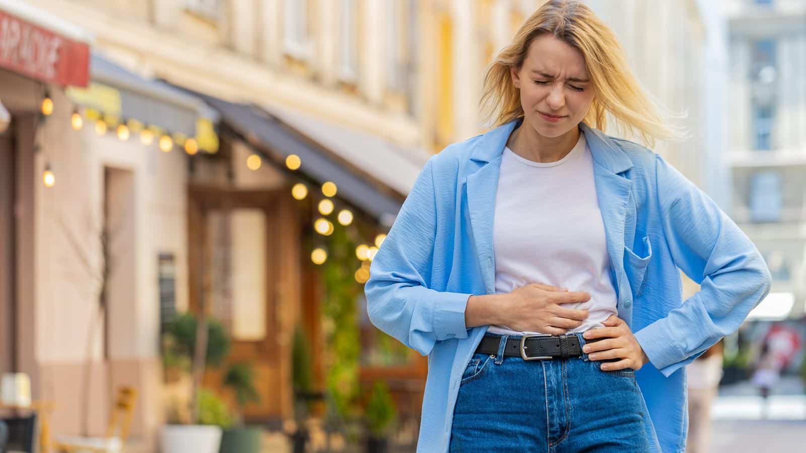 woman holding stomach. gut pain. efurorstudio via 123rf