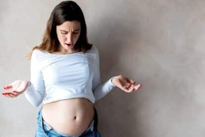woman looking at belly. rolartstudio via 123rf