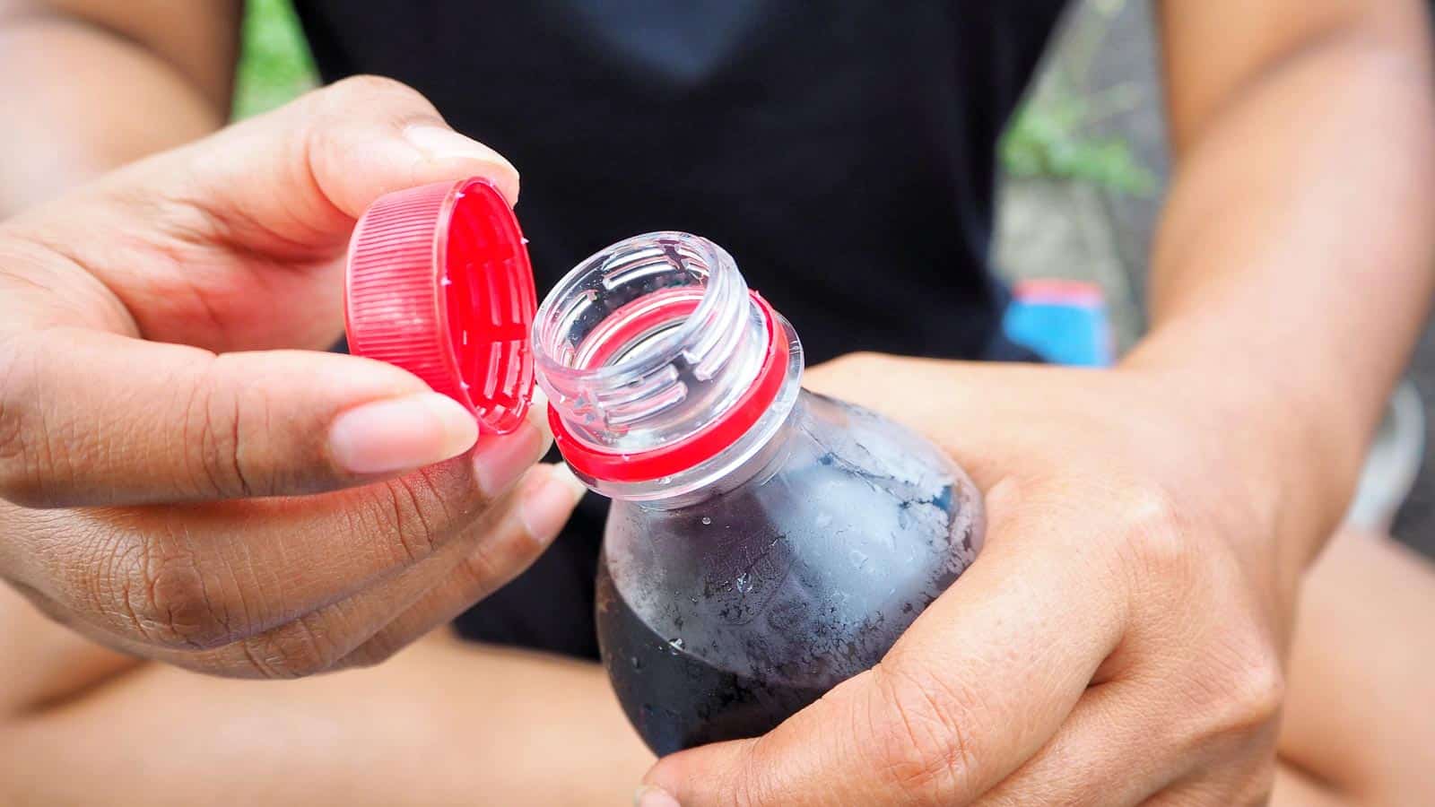 woman opening sodar bottle. photodee via 123rf
