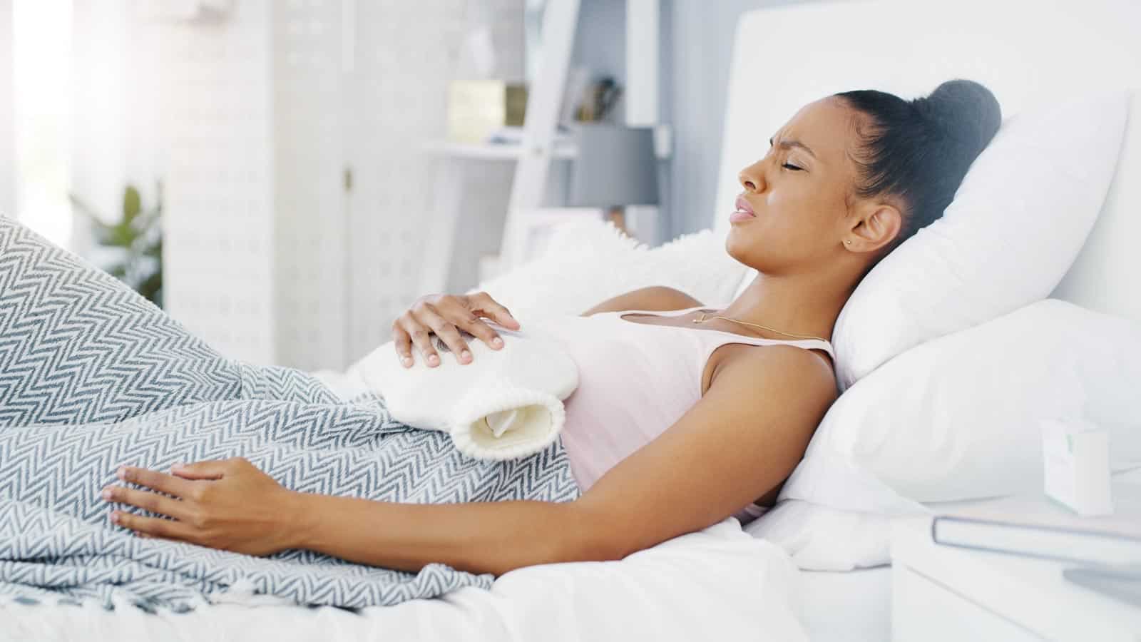 woman with stomach ache and water bottle. peopleimages12 via 123rf