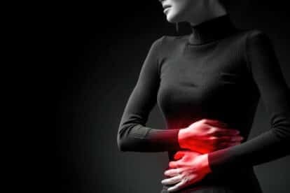 Woman with gut pain. IBS. Holding stomach. marselin888 via 123rf