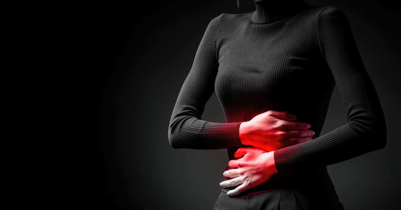 women holding gut in pain. IBS. stomach pain. marselin888 via 123