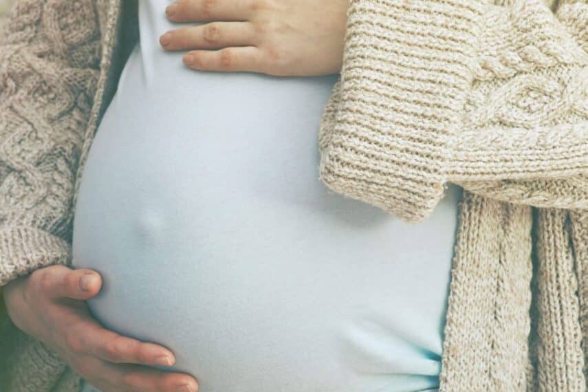 Pregnant woman holding her belly