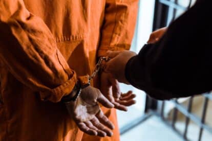 Prison officer wearing handcuffs on a prisoner