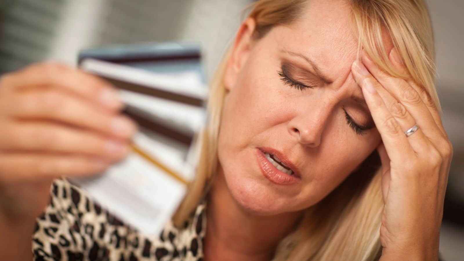 Sad woman holding credit cards