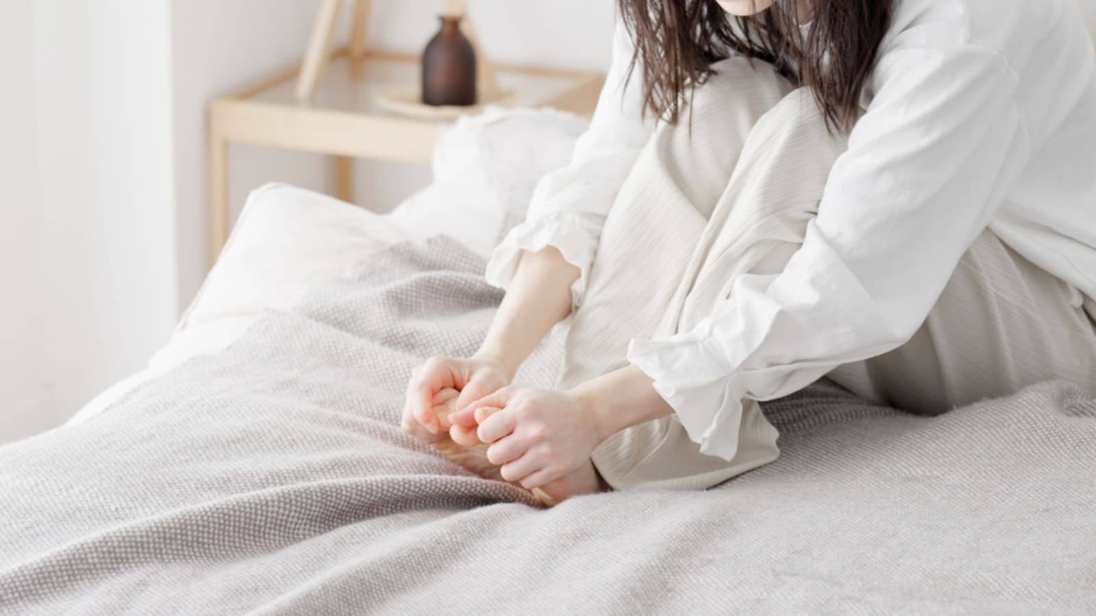 A woman rubbing her cold feet