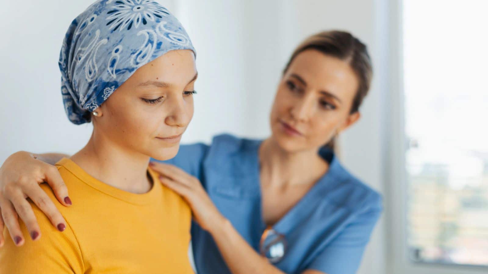 Teenage oncology patient talking with the doctor
