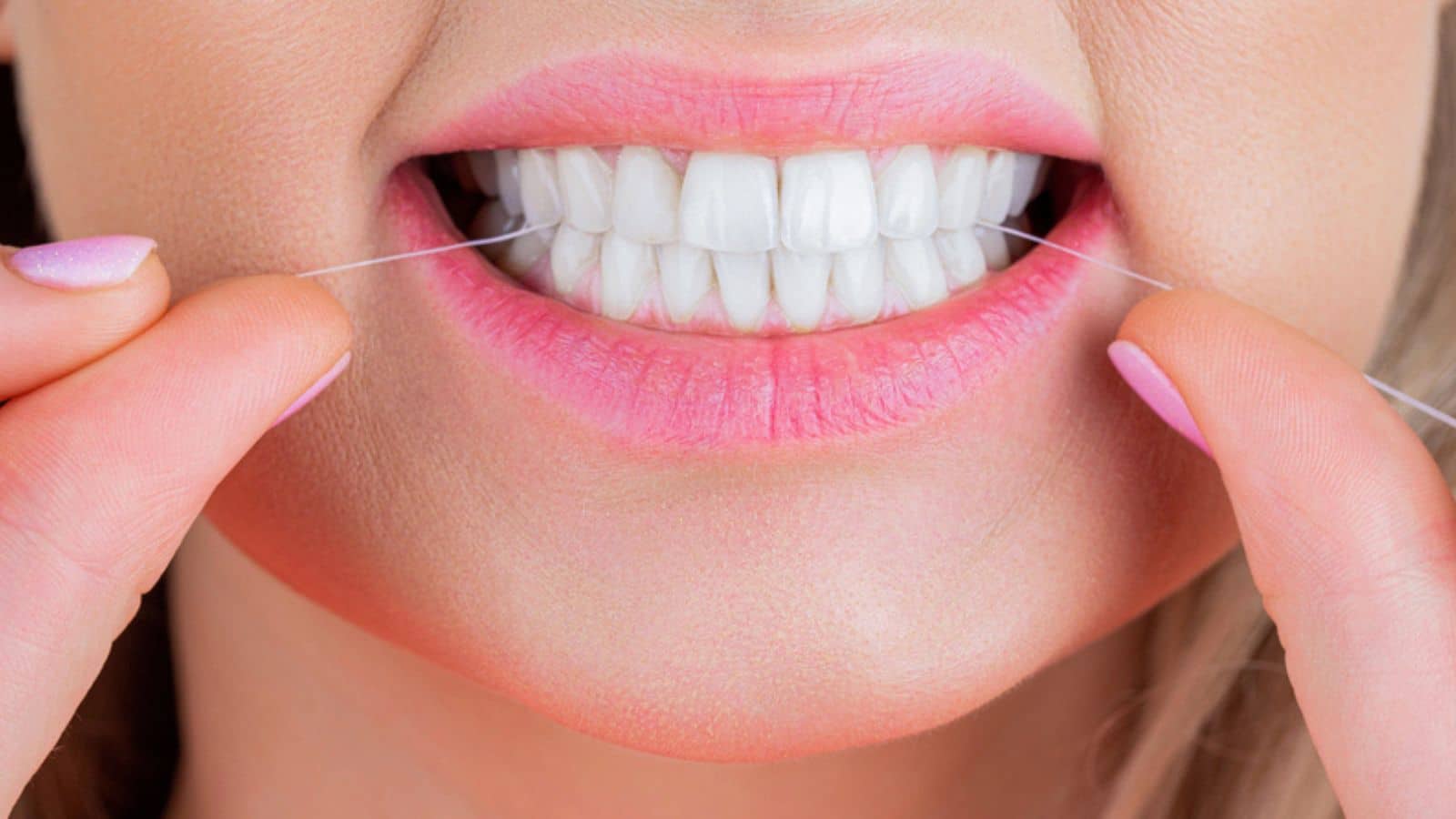 Woman flossing her teeth