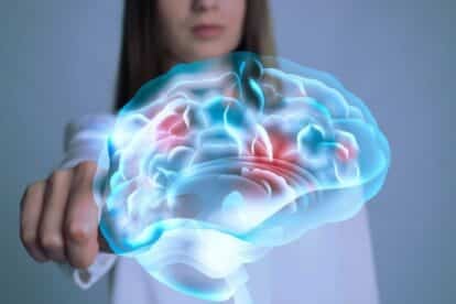 Young woman pointing at digital image of brain