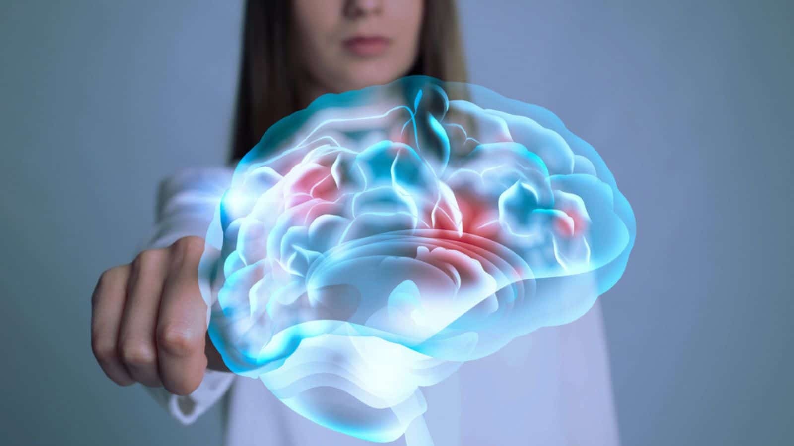 Young woman pointing at digital image of brain