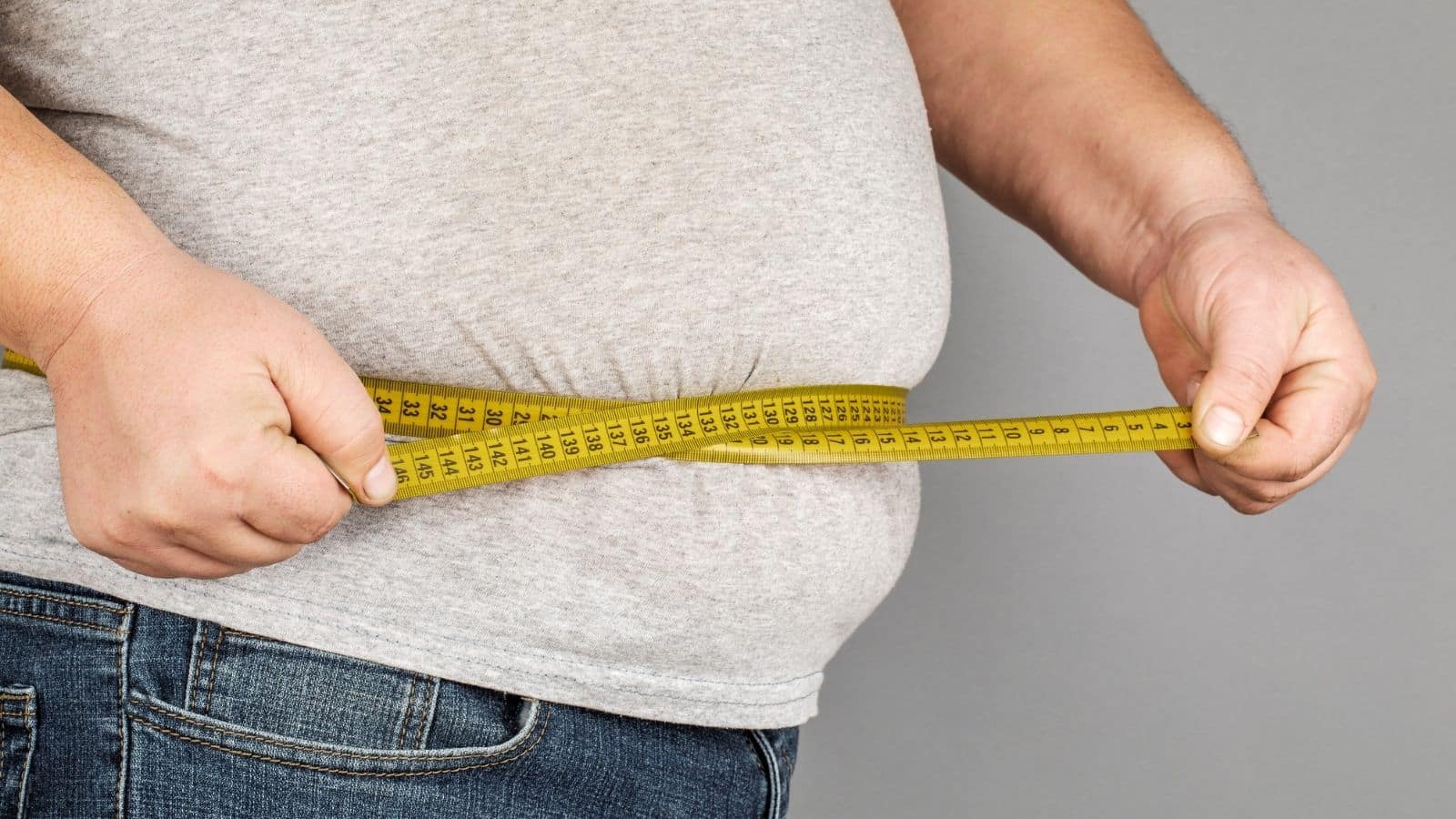 man measuring stomach