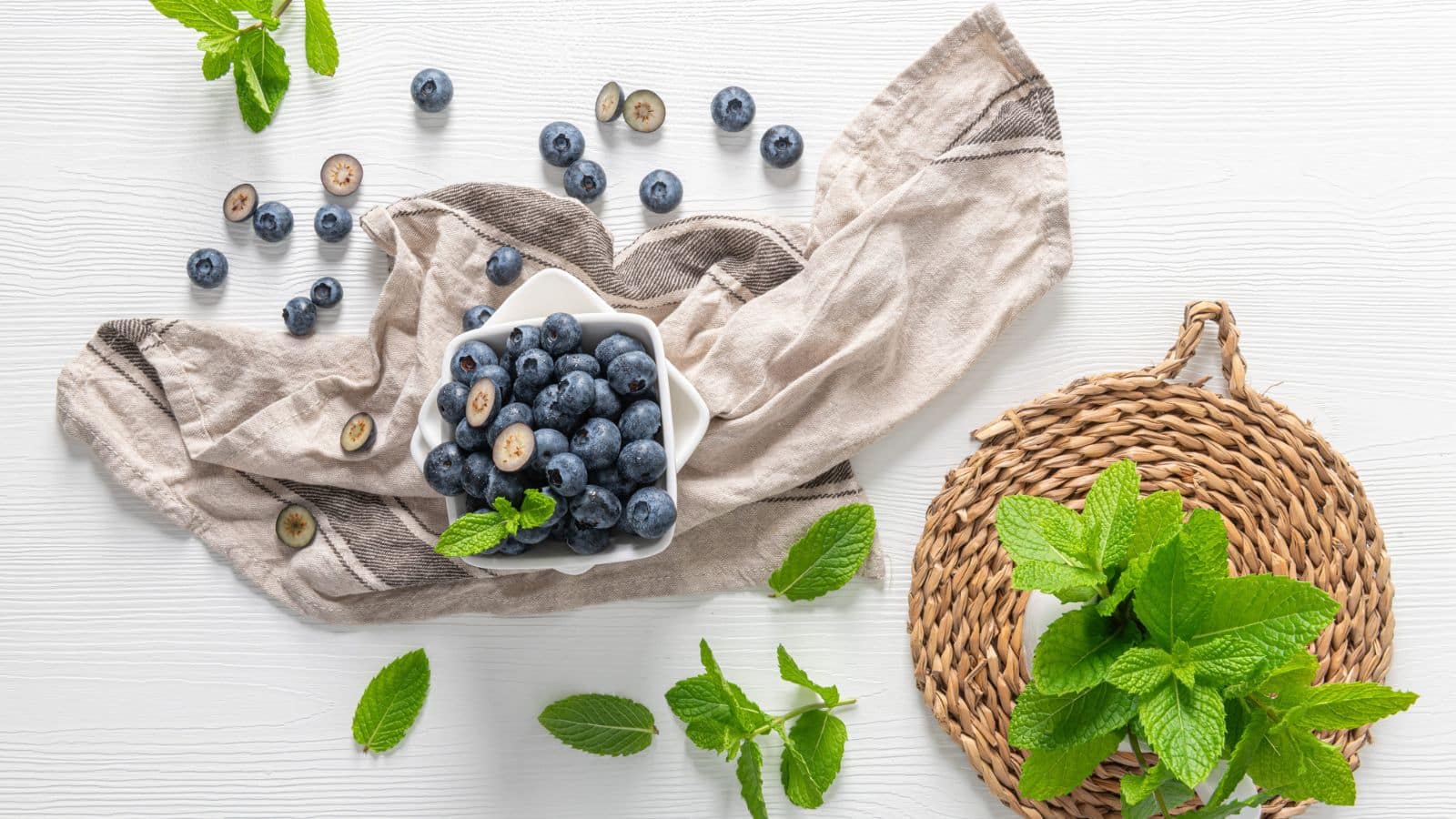 flat-lay arrangement of fresh blueberries in a white bowl