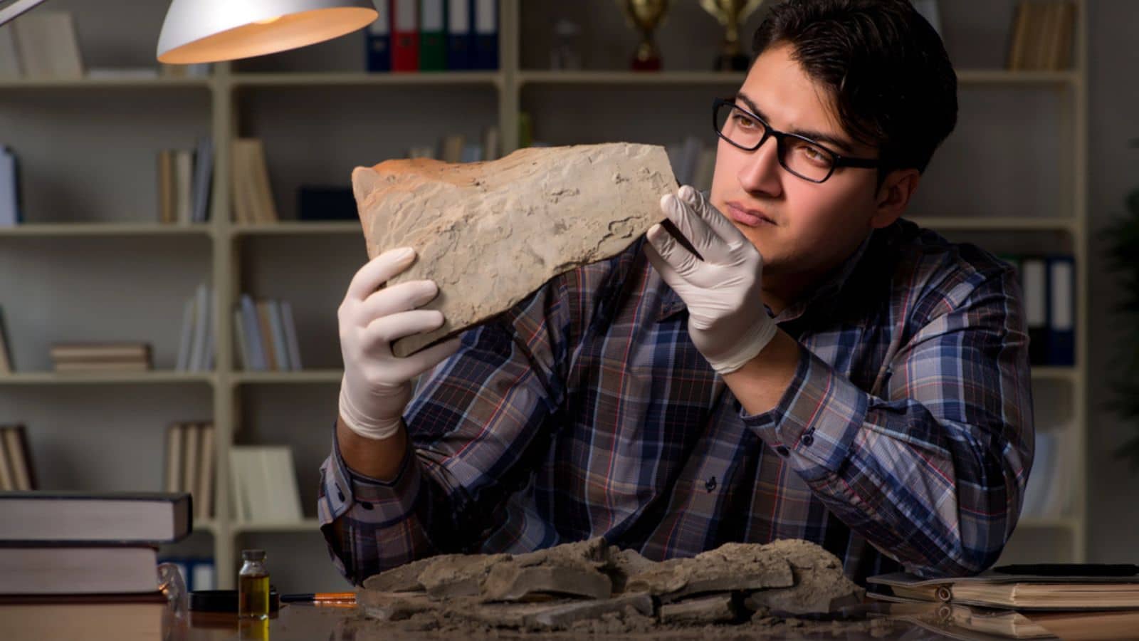 Archeologist working late night in office
