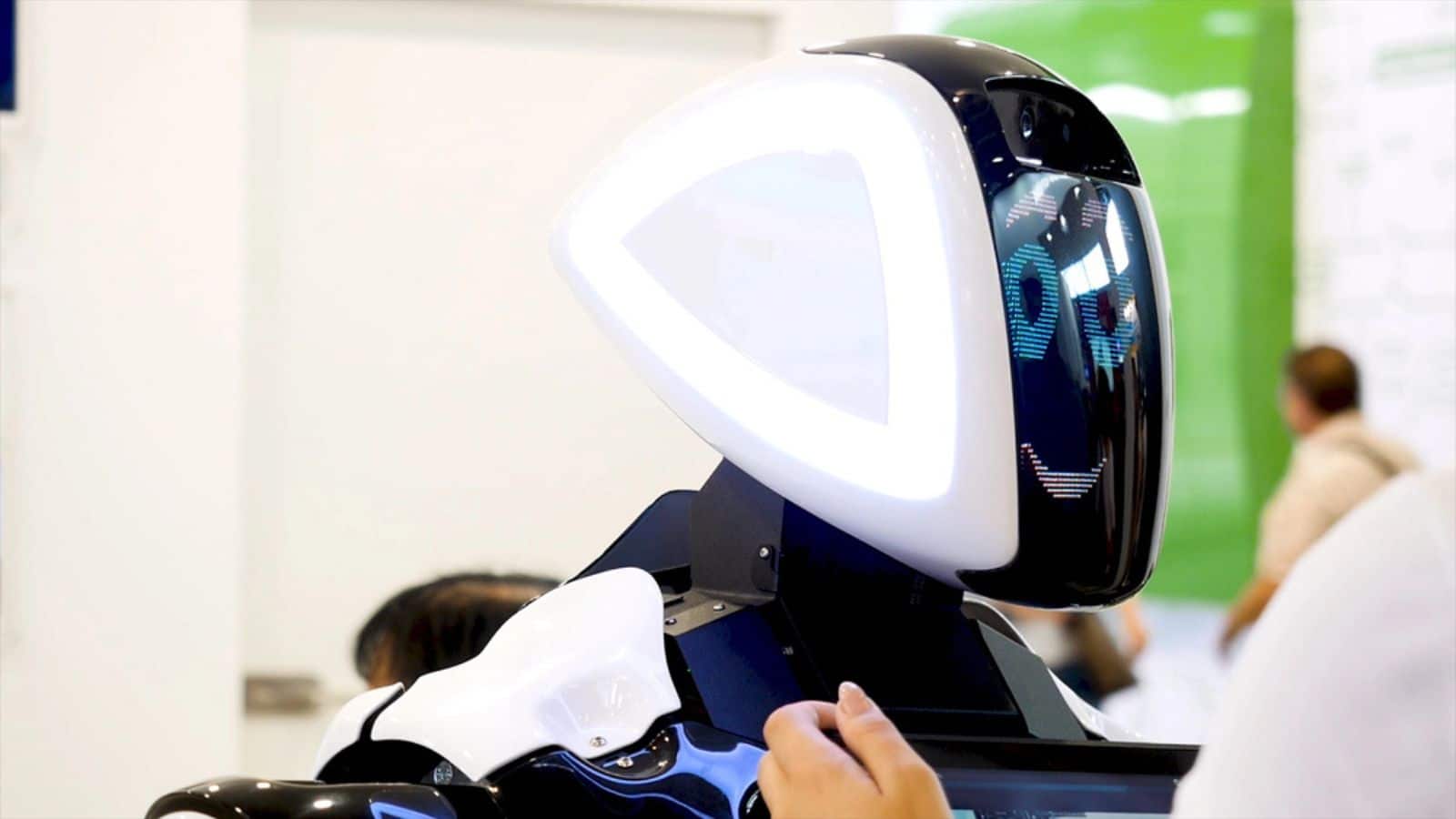 Big funny robot with big blue eyes smiling and talking