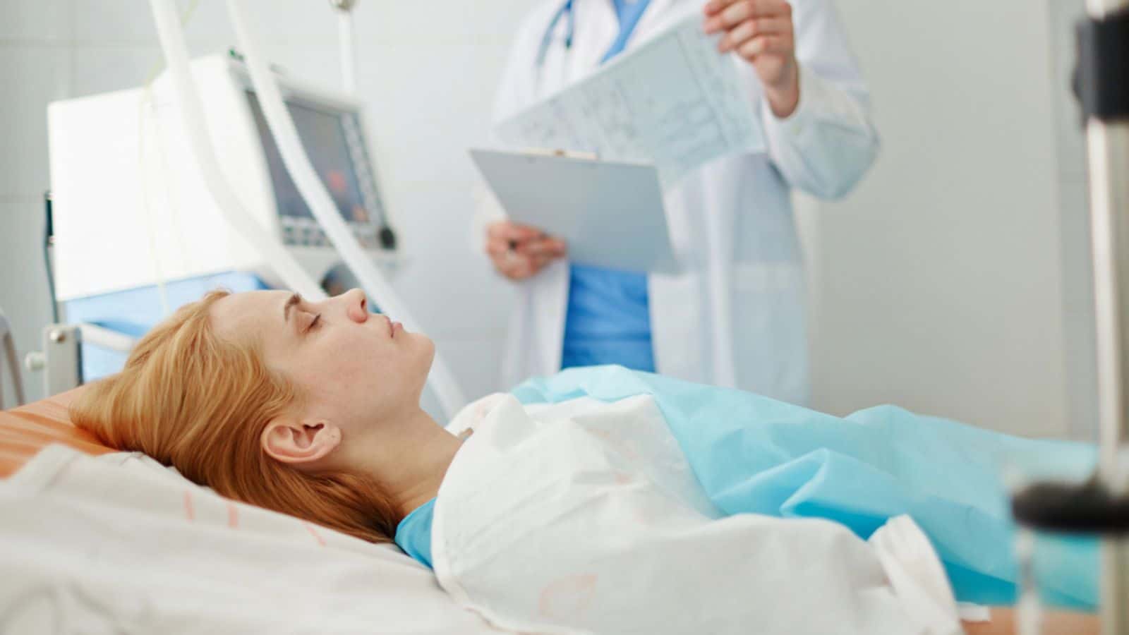 Unconscious woman lying on bed